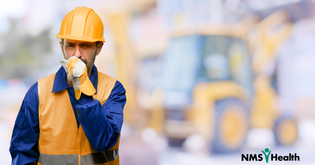 Worker in hardhat coughing